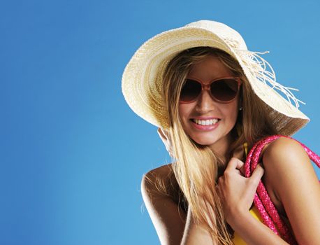 Smiling young woman against blue background, copy space