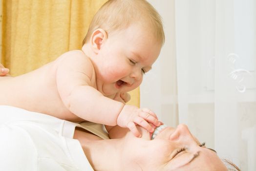 Small baby, playing with mother