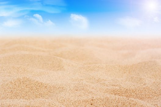 Sand and sky with clouds and sun background