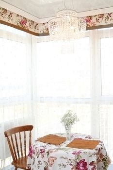 interior of modern kitchen, view of a window and little table with chairs, a vertical shot