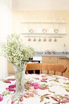 interior of the modern apartment, table with a bunch of flowers, a vertical shot