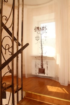 view of a window with a beautiful curtain from a ladder, a vertical shot