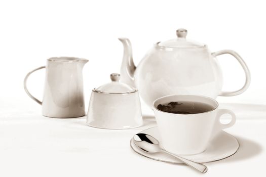 Cup of tea with tea pot