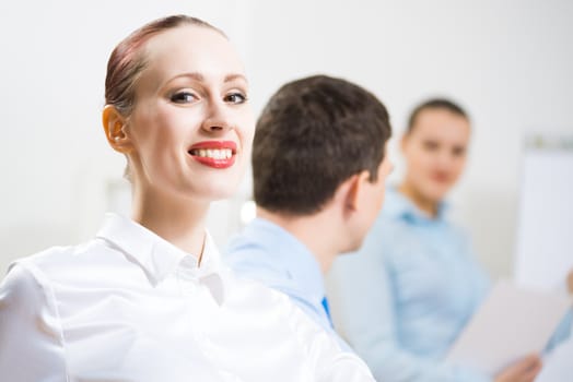 business woman doing a report next presentation boards, listening to her colleagues