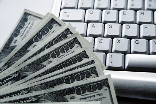 dollar banknotes on a background an aluminium computer keyboard
