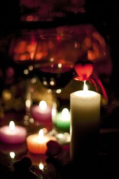 romantically colored candles burning with a beautiful reddish bokeh