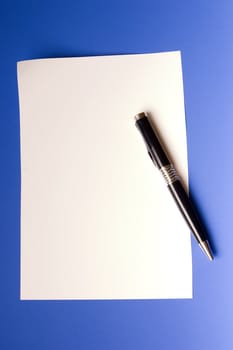modern beautiful pen and sheet of white paper on a dark blue background