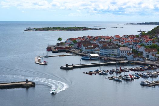 Motorboat entering the harbor of Risor in Southern Norway