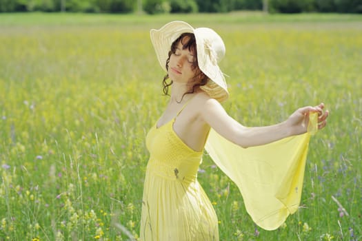 Young woman enjoying a summer day on the field