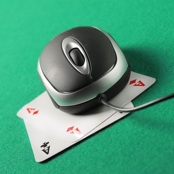 Computer mouse on top of a pair of aces