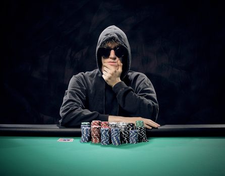 Portrait of a professional poker player sitting at a poker table