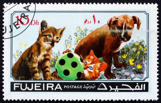 FUJEIRA - CIRCA 1971: a stamp printed in the Fujeira shows Dog and Cat, Pets, circa 1971