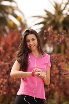 Sport woman checking heart rate in pink watch