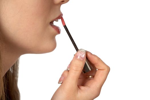 The girl painting lips on a white background