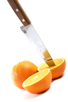 Knife and orange cut half-and-half on a white background