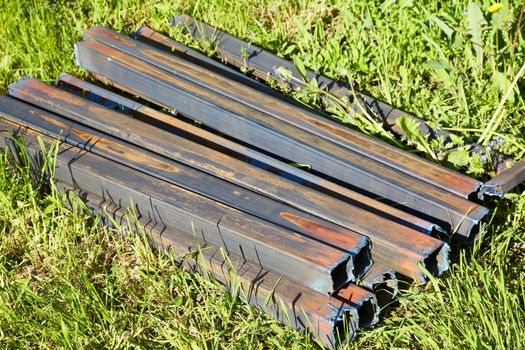 Group of metal beams in green grass