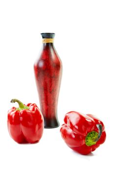 Flower vase and two red paprika on a white background