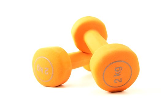 Pair of orange dumbbells isolated on a white background