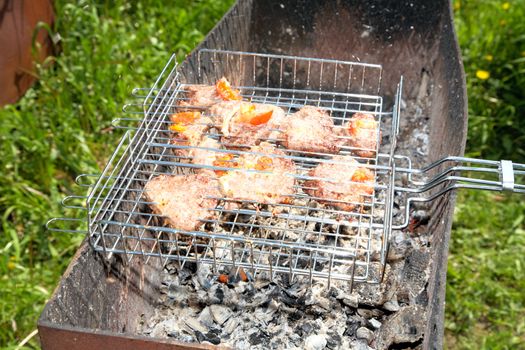 Meat on a grill in the solar spring afternoon