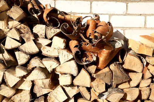 Stack of freshly cut fire wood shined with the sun
