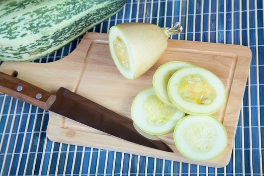 The cut vegetable marrow on  chopping board a close up