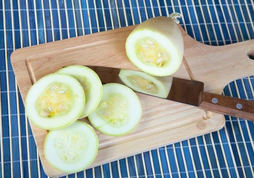 The cut vegetable marrow on  chopping board a close up