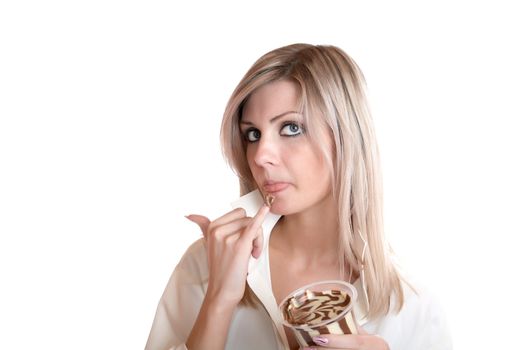 The girl eats chocolate paste on a white background