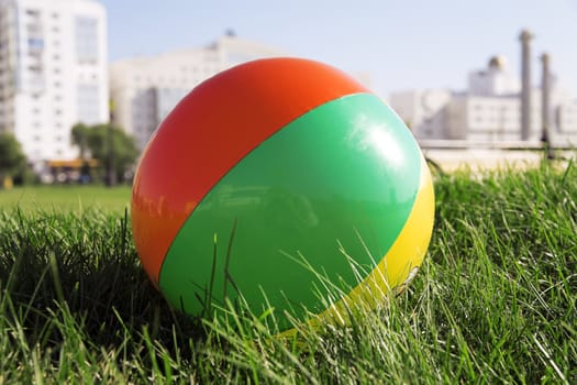 ball for outdoor games lying on grass in city park