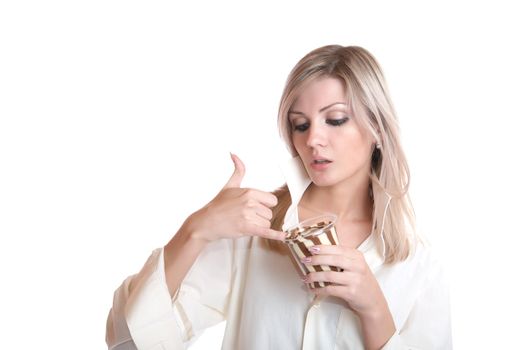 The girl eats chocolate paste on a white background
