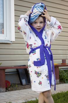 The little girl after water procedures in summer times