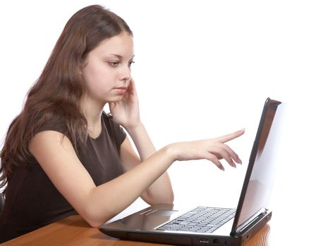 girl points  finger at the laptop screen on a white background