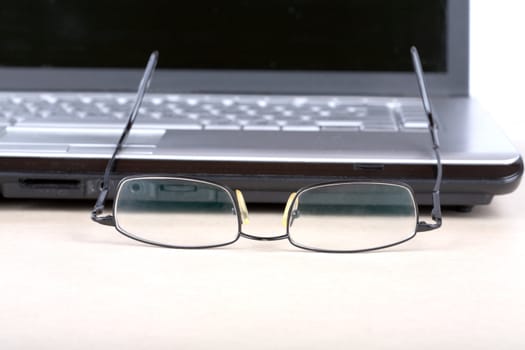  glasses and notebook on a desk