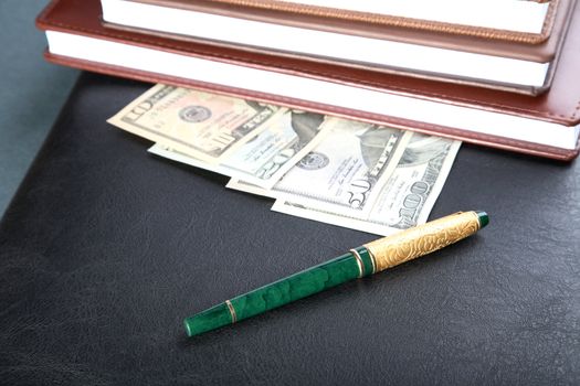 Folder organizers  pen and money on a table