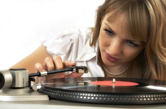 The girl listens to a vinylic disk