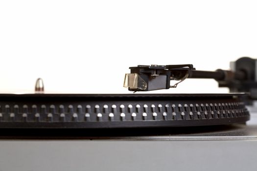 Old  player and vinyl phonograph record on a white background