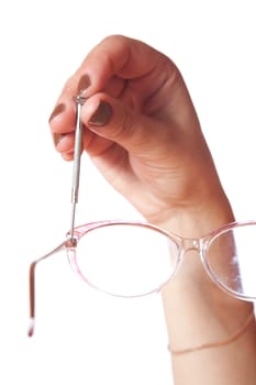 Female hand with screw-driver and glasses on a white background