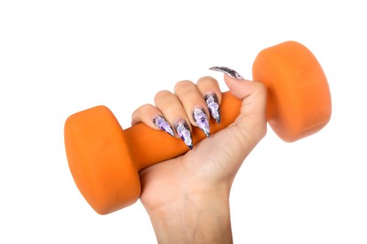 female hand with manicure holds  dumbbell isolated on a white background