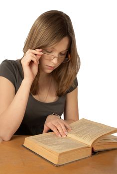 The girl in glasses reads the book on a white background