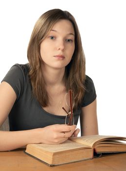 The girl in glasses reads  book on a white background