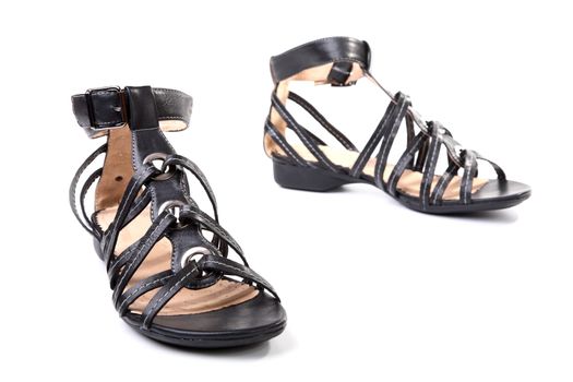 Pair of black female sandals on a white background