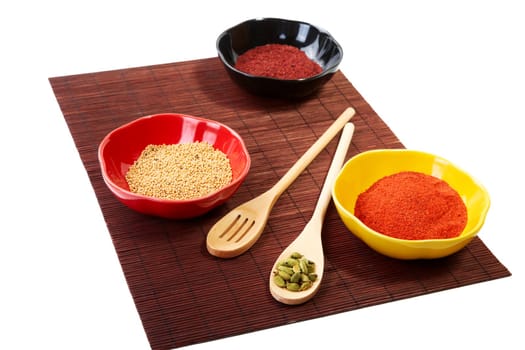 Still-life with spices in plates on a white background