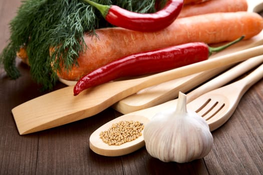 Spices and vegetables on an old wooden table