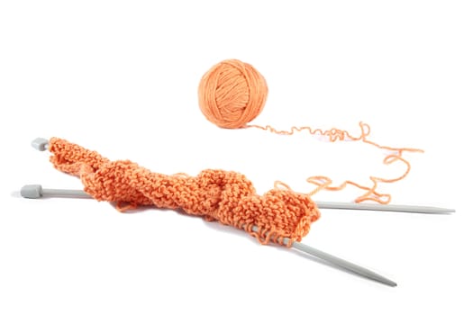 Knitting spokes with ball of wool on white background