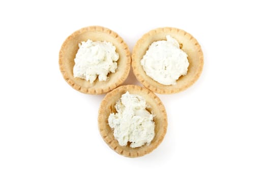 Tartlets with soft cheese isolated on a white background
