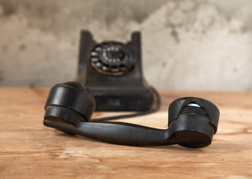 Old phone against the plastered wall