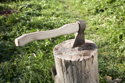 Axe with  pack for cabin against a green grass