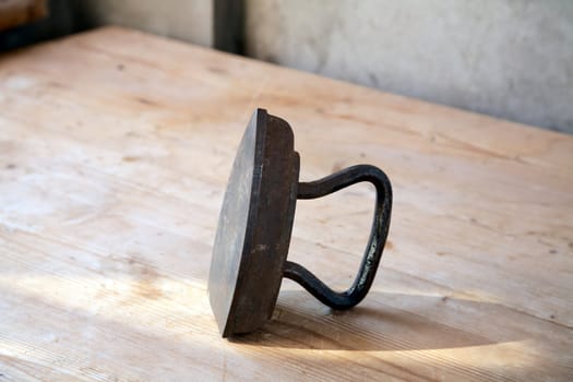 The old iron on a table in beams of the coming sun