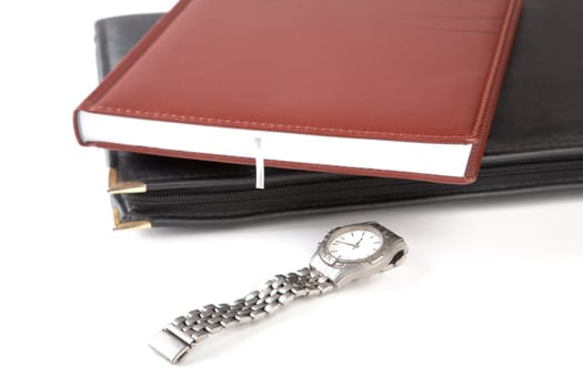 Folder for papers, organizer and watch on a white background