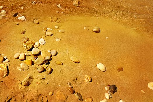 Pebbles on a sand sea shore