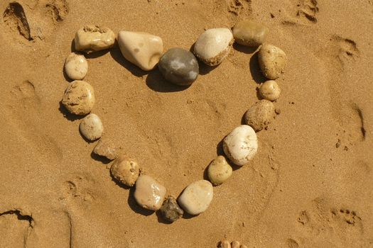 Love heart from pebbles on a tropical beach